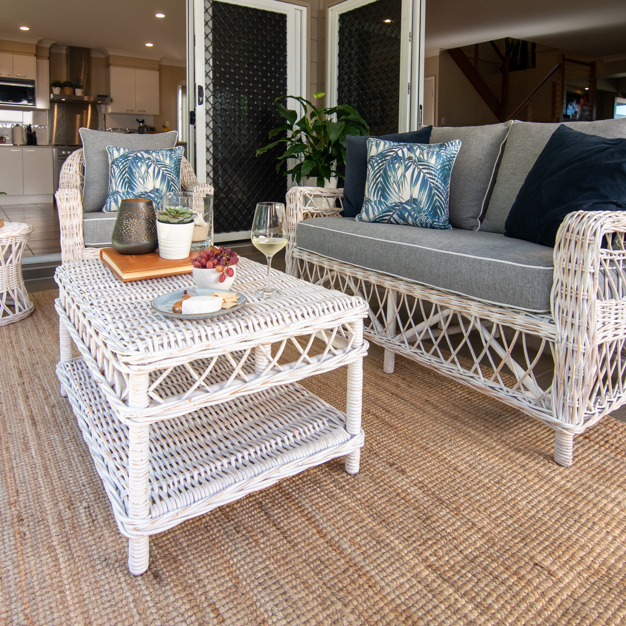 Napa setting in white washed on an alfresco setting in a home with upgraded hamptons fabrics, wine and cheese plate